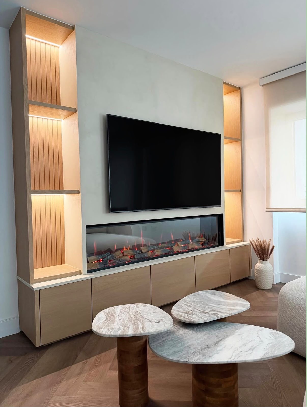 Bespoke oak media wall with wall-mounted TV, inset linear fireplace and backlit fluted display niches