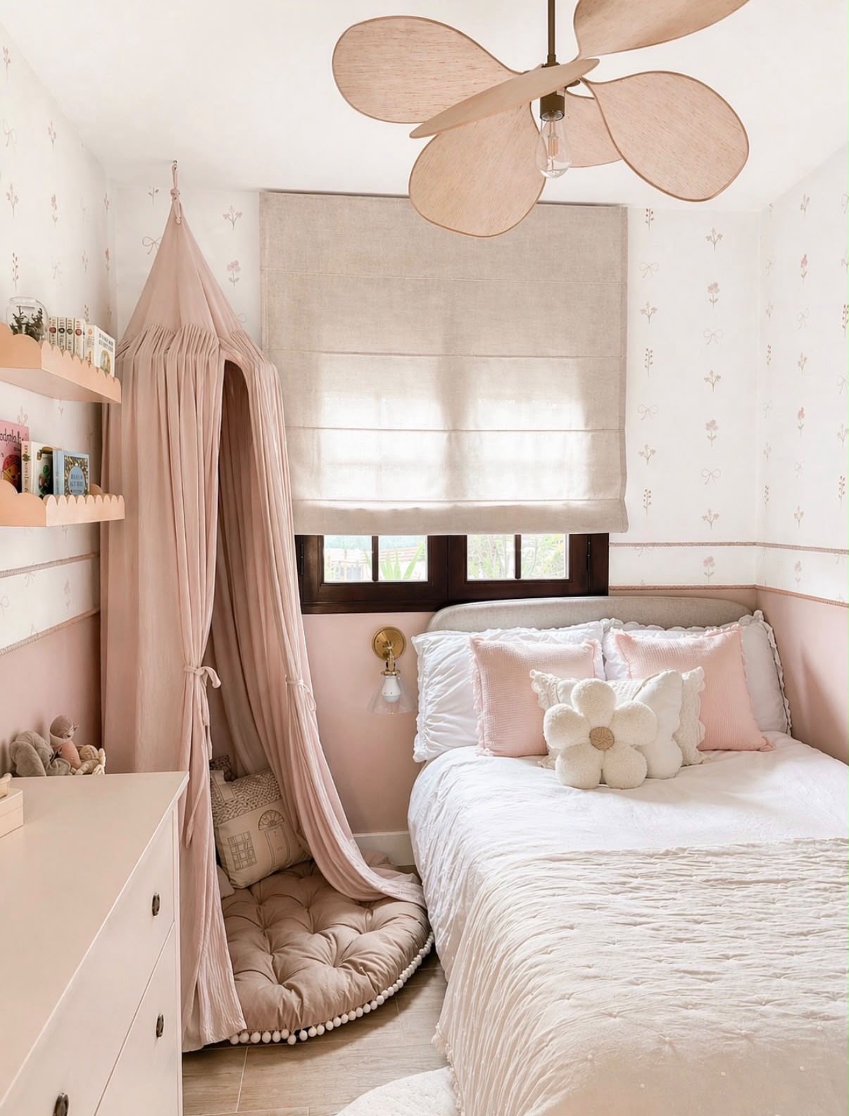 Girl's bedroom with blush pink canopy reading nook, floral wallpaper and scalloped bookshelves