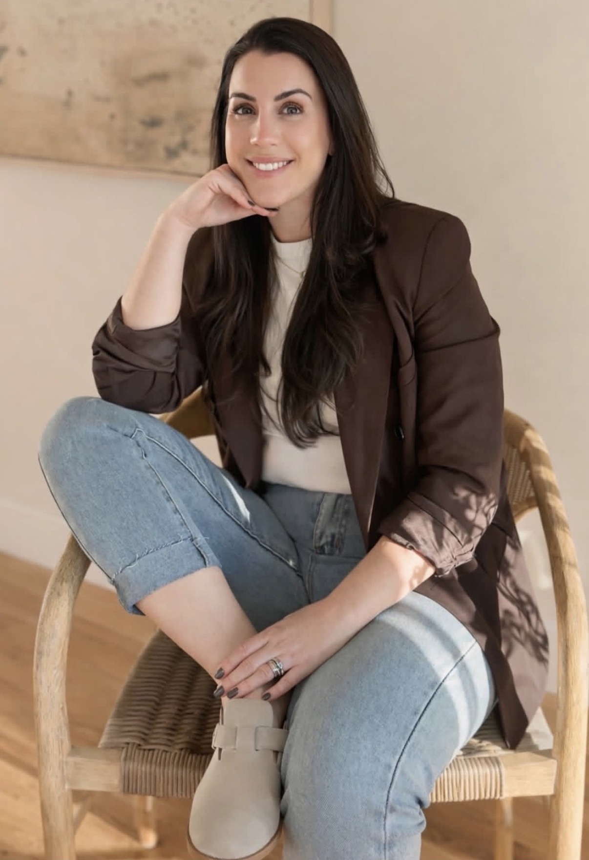 Founder of Clo Interior Designs seated in a warm neutral interior