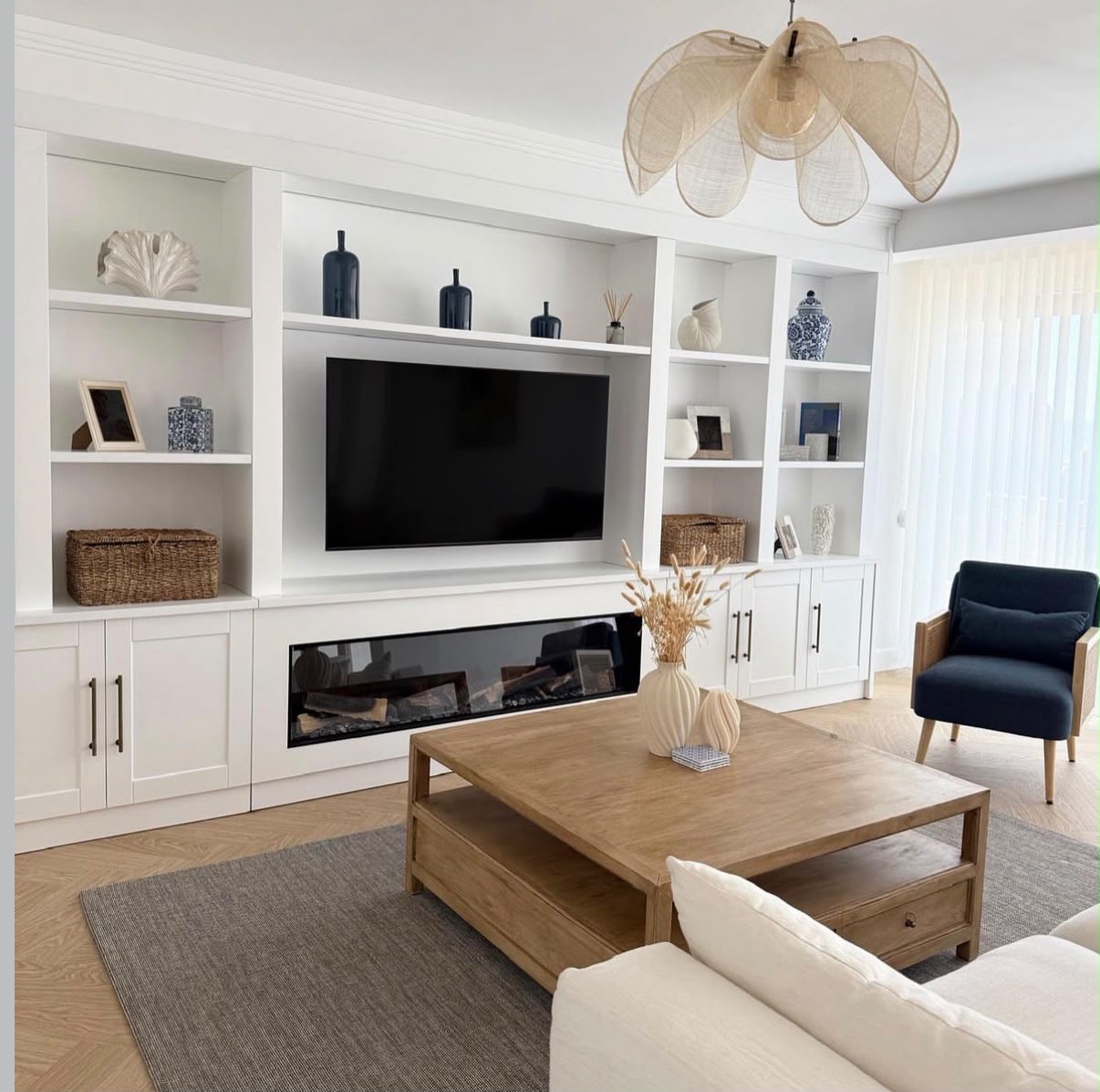 Classic white media wall with open shelving, cabinetry and inset linear fireplace